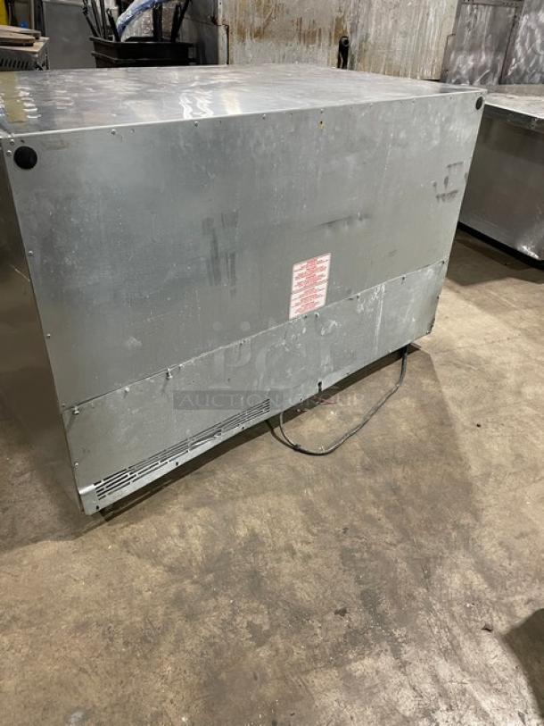 Silver King SK48G commercial stainless steel 2-door undercounter freezer, worn condition, with poly coated wired rack, 115V.