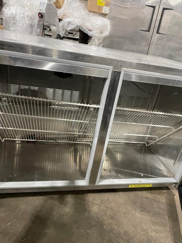 Silver King SK48G 2-door stainless steel undercounter freezer with glass doors, poly coated rack, 115V, model label visible.