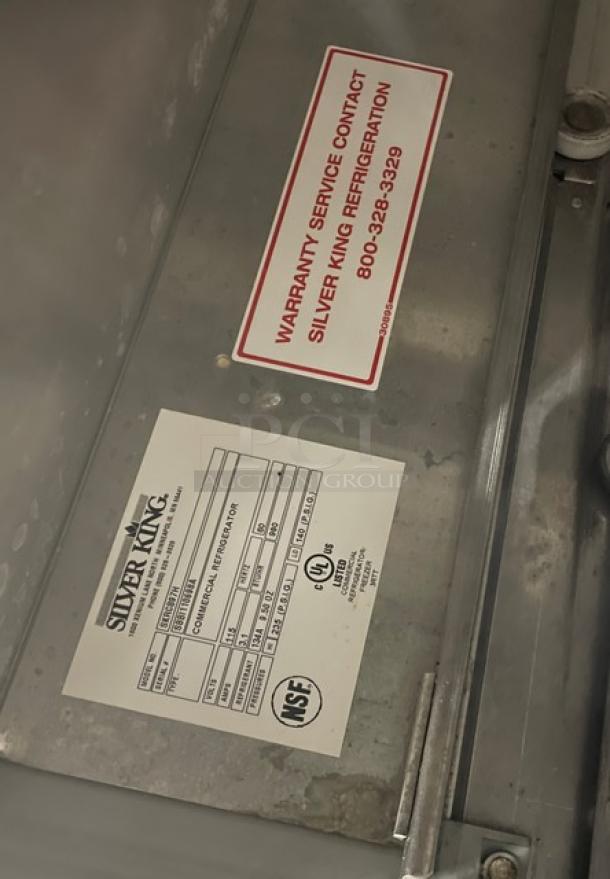 True TSUU-48-08 stainless steel electric pizza prep table, NSF certified, features Silver King warranty tag and specs label.