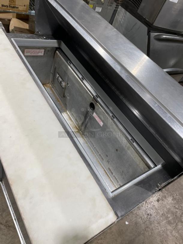 Commercial stainless steel refrigerated bain marie salad/sandwich prep table with cutting board, on casters.