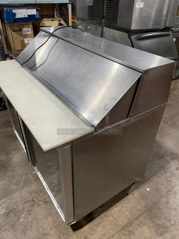 Commercial stainless steel refrigerated bain marie salad/sandwich prep table with cutting board, on casters, gently used.