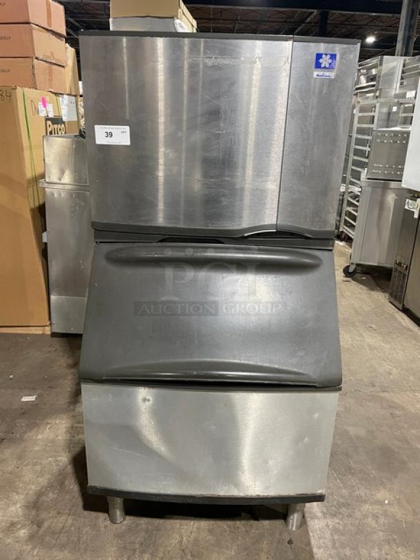 Manitowoc stainless steel electric ice making machine with bin, lift open access, on legs. Commercial use.