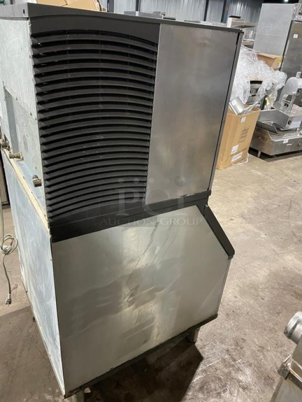 Manitowoc stainless steel ice making machine with bin combo, electric powered, lift open access, on legs, in used condition.