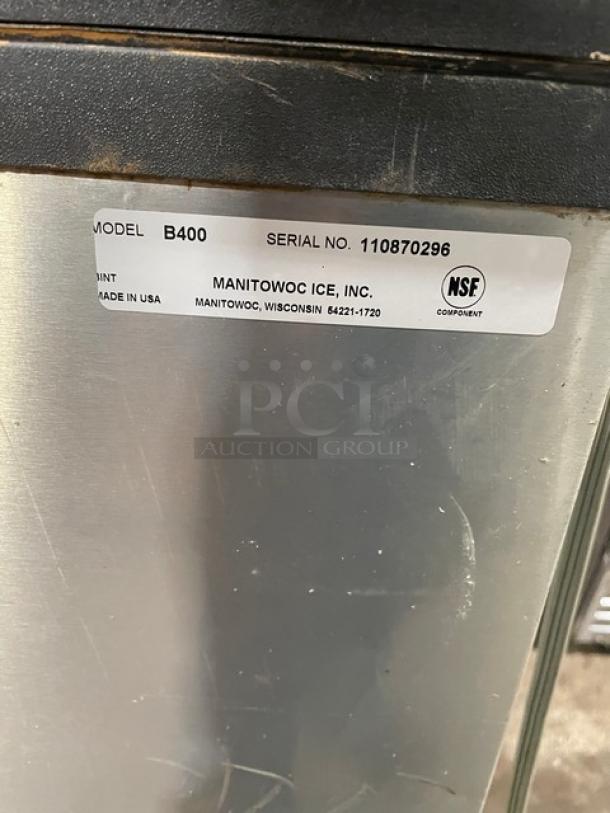 Manitowoc stainless steel ice machine/bin combo, model B400. Features lift open access, NSF certified, on legs.