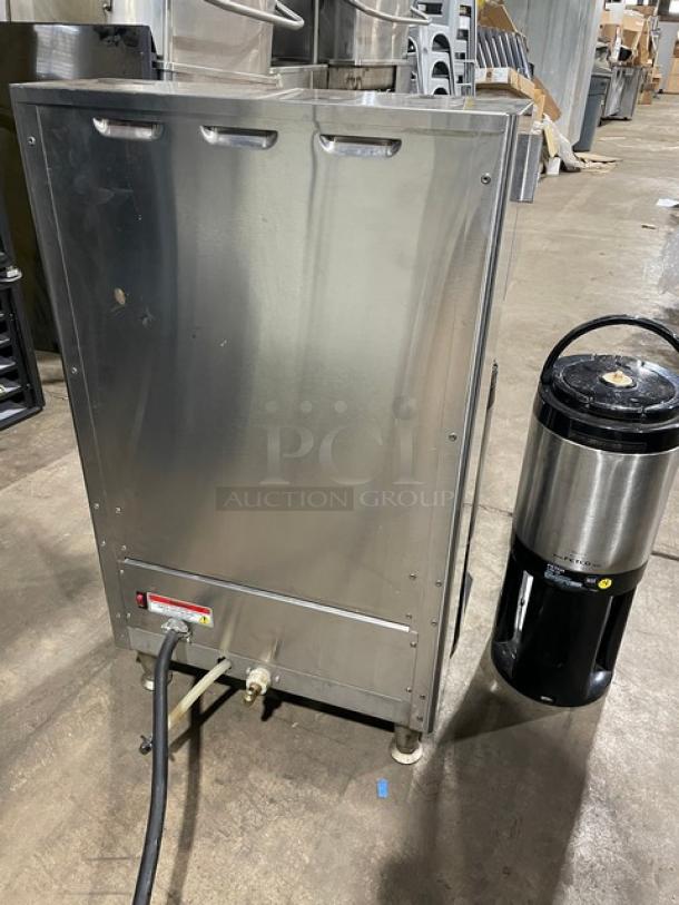 Fecto CBS-2142-XTS automatic coffee brewer on legs with satellite air pot, shown in industrial setting, stainless steel finish.