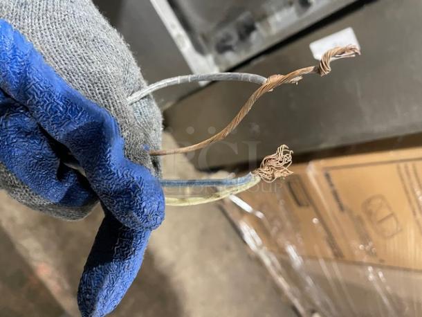 Hoshizaki KM-650MAH ice machine wiring shown against the machine body, highlighting disconnected and worn wires.