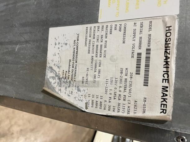 Hoshizaki KM-650MAH ice machine label showing model, voltage, and specs. Stainless steel, air-cooled, electric-powered.
