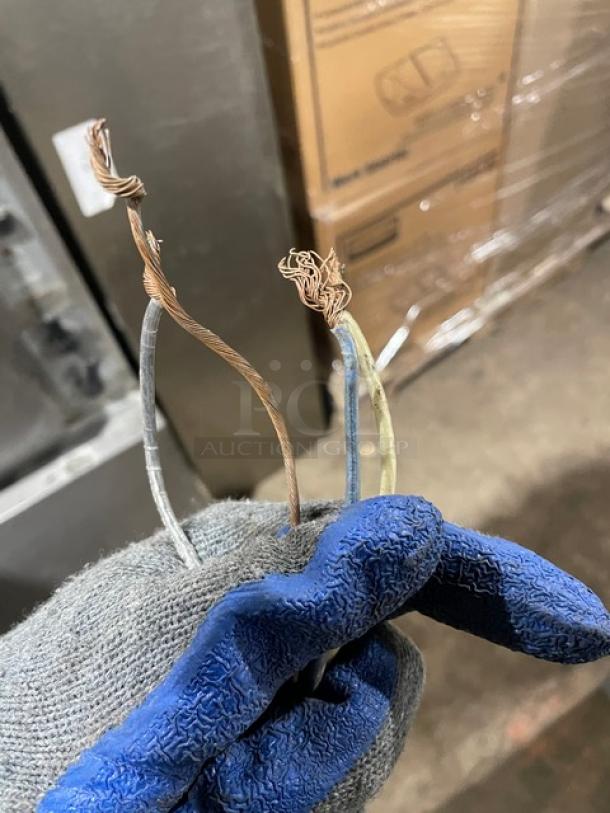 Close-up of wires from Hoshizaki KM-650MAH ice machine, indicating disassembled or repair condition.