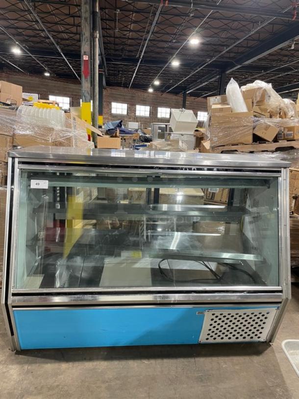 Leader commercial stainless steel refrigerated merchandiser, model HDL72SC, with slanted glass and adjustable shelving, rear access sliding doors.