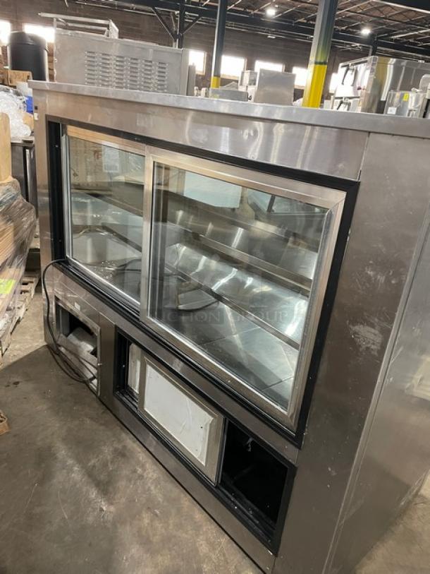 Leader commercial stainless steel slanted glass refrigerated merchandiser, model HDL72SC, with adjustable shelving and rear access sliding doors.