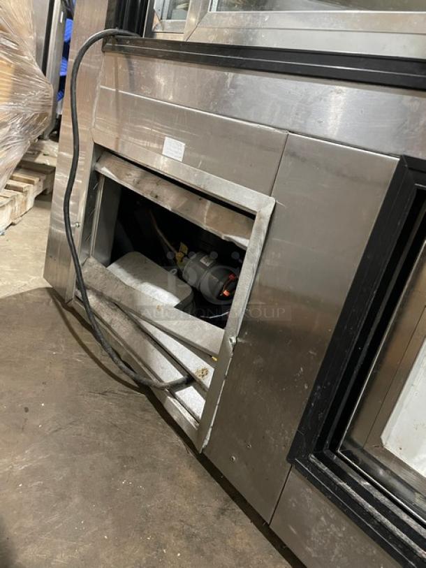 Leader HDL72SC refrigerated merchandiser with slanted glass, adjustable shelving, rear access doors. 115V, 1 phase.