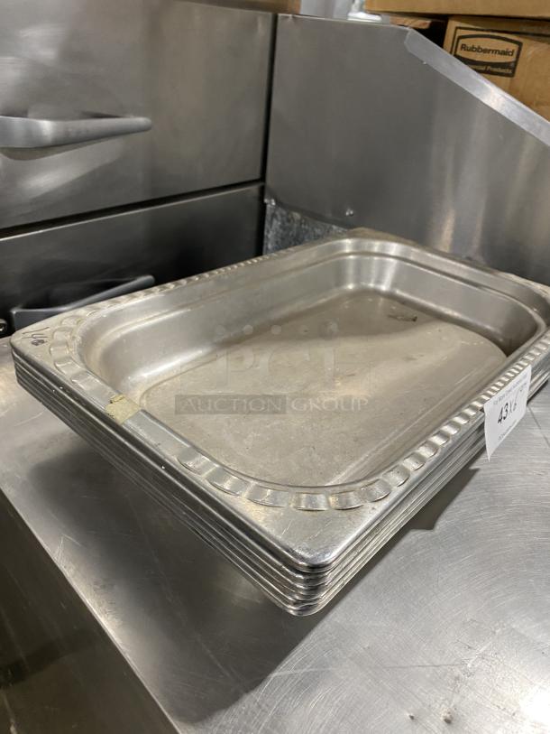 Stack of commercial stainless steel stackable food serving trays, used condition, slight wear visible, with auction tag "4313".