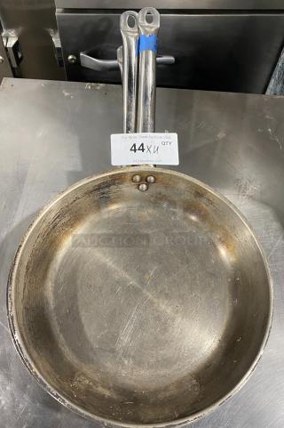 Commercial round frying pan with dual handles, metal construction, used condition. Auction tag reads "44XU QTY."