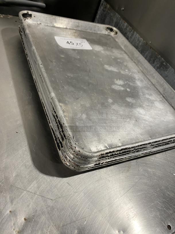 Commercial stainless steel full-size sheet pan, worn condition, visible scratches and rust, auction label "45 X".