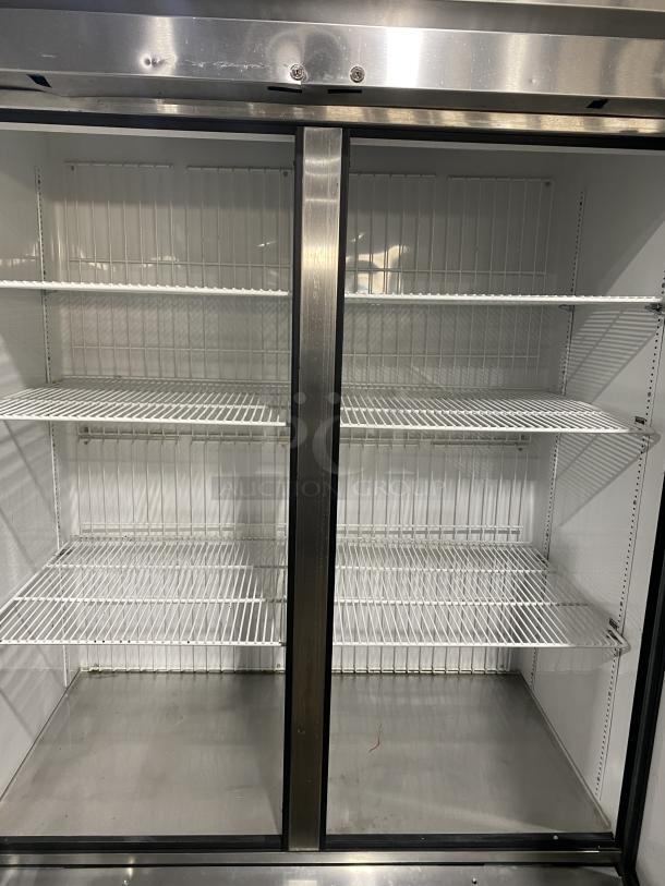 True T-49F commercial stainless steel 2-door reach-in freezer with poly coated racks, Energy Star certified, on casters.