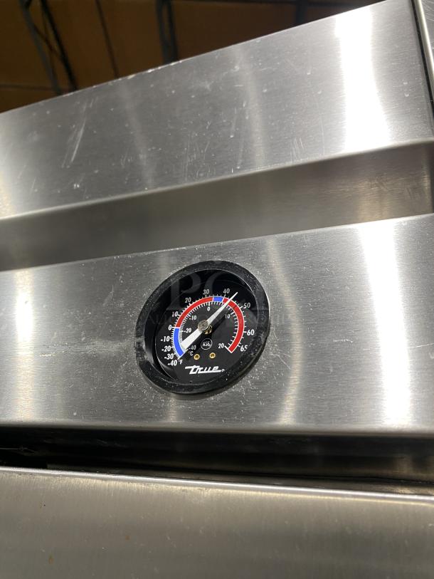 True T-49F Commercial Stainless Steel Freezer, 2 doors, poly coated racks, Energy Star, temperature gauge shown, on casters.