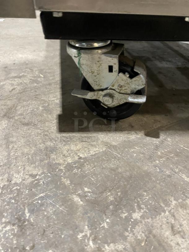 True T-49F reach-in freezer caster detail, showing sturdy dual-wheel design for mobility. Model: T-49F.