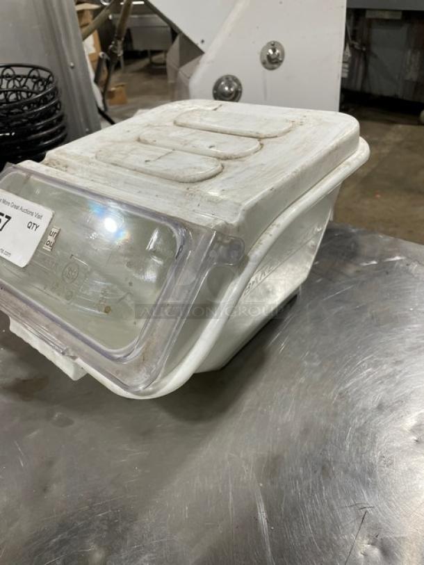 Commercial white ingredient bin with clear lid, used condition, visible wear. Marked with auction label #27.
