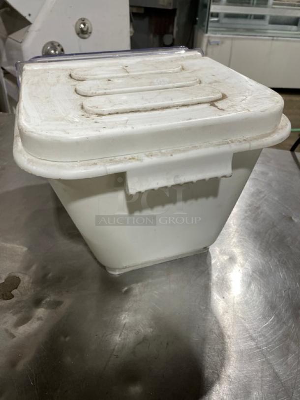 Commercial white ingredient bin with lid, showing mild wear. Ideal for storing bulk ingredients in kitchen settings.