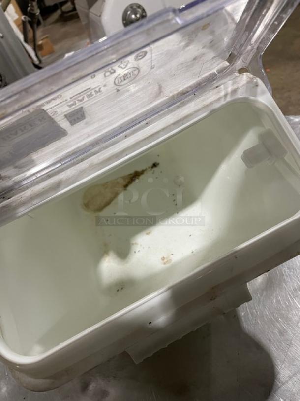 Commercial white ingredient bin with clear lid, visible dirt, and wear. Ideal for kitchen storage. Minor cleaning needed.