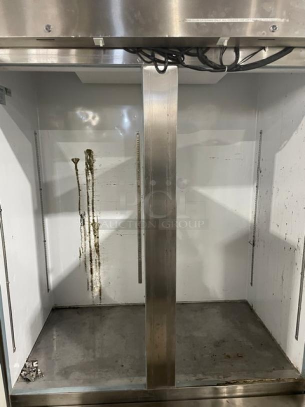 Arctic Air AF49 2-Door Stainless Steel Reach-In Freezer, Model 311709, 115V, on casters, interior stains visible.