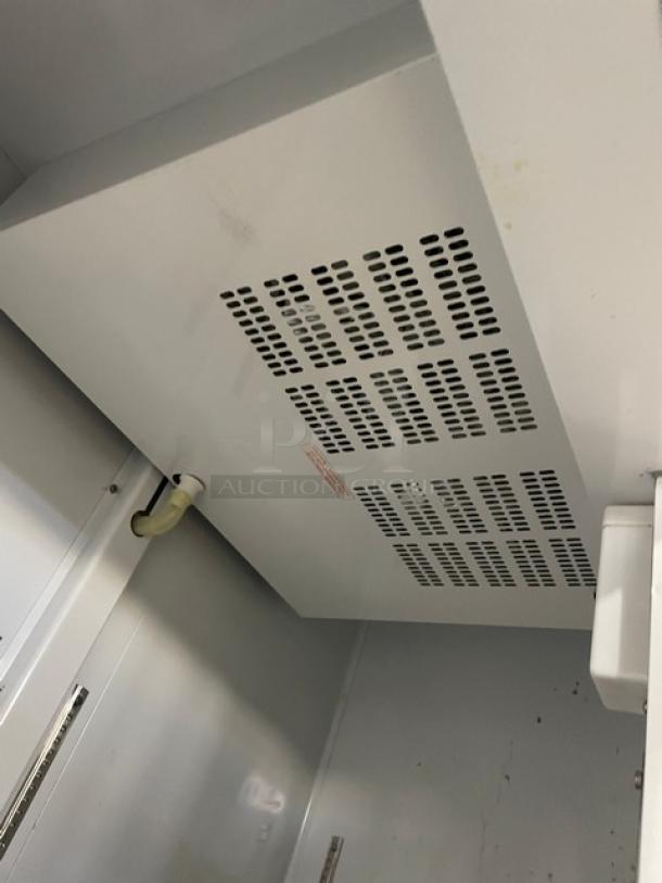 Arctic Air AF49 stainless steel 2-door freezer interior view. Model and SN label visible. Excellent commercial kitchen appliance.