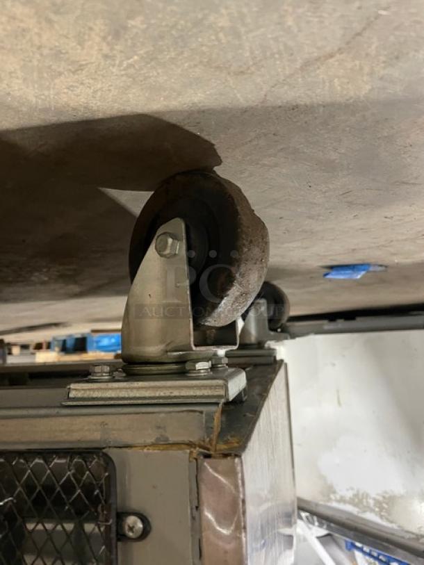 Arctic Air AF49 stainless steel 2-door reach-in freezer, model SN: 311709, 115V, on casters, commercial-grade condition.