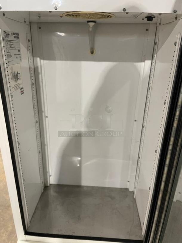 True Commercial GDM-10SSL-LD beverage refrigerator. White, single glass swing door, clean interior. Model and serial number labels visible.