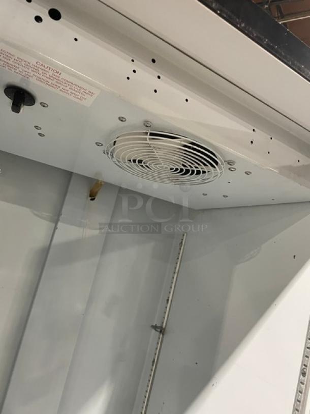 Beverage Air MT12 commercial cooler interior, showing fan and shelving. Single glass door model, black, 115V, 1 phase.