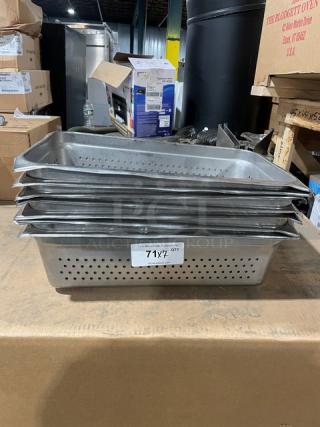 Commercial stainless steel full-size perforated steam table buffet pans. Stack of seven with visible label "7X" indicating quantity.