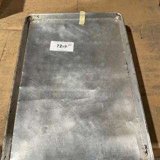 Commercial aluminum full-size sheet pan, used, with label "72x9 QTY." Durable, suitable for large-scale baking.