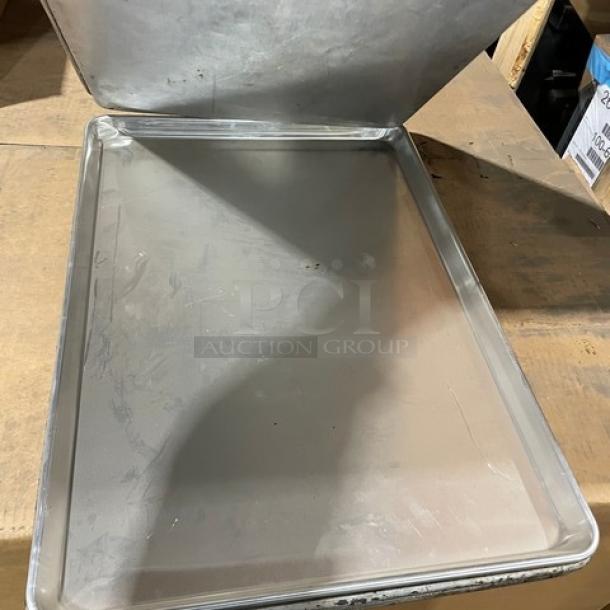 Commercial aluminum full-size sheet pan, lightly used with minor surface marks. Ideal for baking and food service.