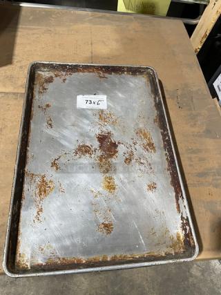 Commercial aluminum full-size sheet pan, worn condition with visible rust. Labeled "73 x 6X."