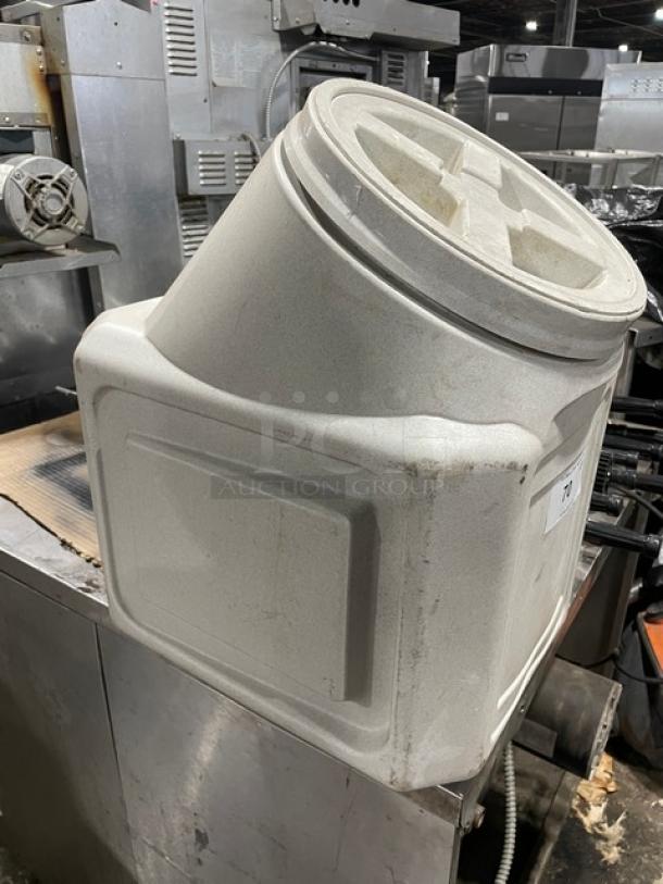 Commercial white ingredient bin with slanted lid. Sturdy plastic, used condition with visible wear. Ideal for bulk storage.