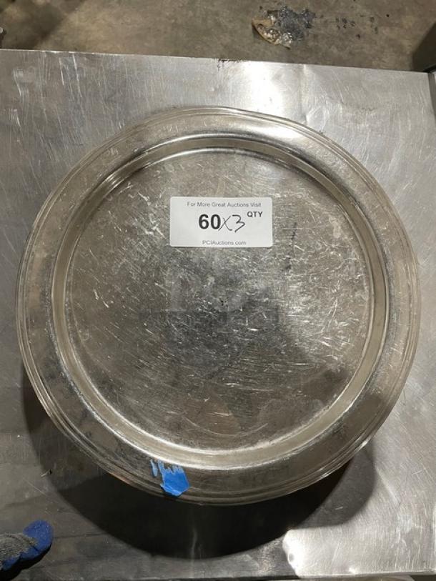 Commercial stainless steel plate, round, with visible scratches, quantity label indicating 60 units in the lot, sturdy condition.
