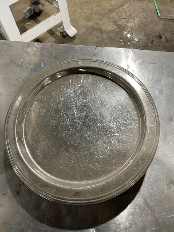 Commercial stainless steel plate, industrial-grade, showing moderate wear. Durable and scratch-resistant.