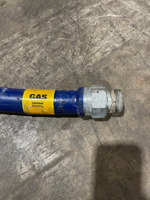 Dormont commercial gas connector hose, durable blue with yellow safety label, metal fittings, used condition.