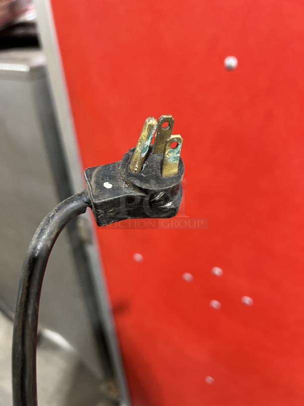 Close-up of a power plug for a Beverage-Air Commercial 3 Door 72" Worktop Refrigerator, model WTR72AY.