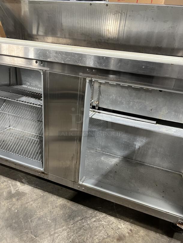 Continental SW60-16 stainless steel refrigerated sandwich prep table, dual doors, used condition, visible shelving.