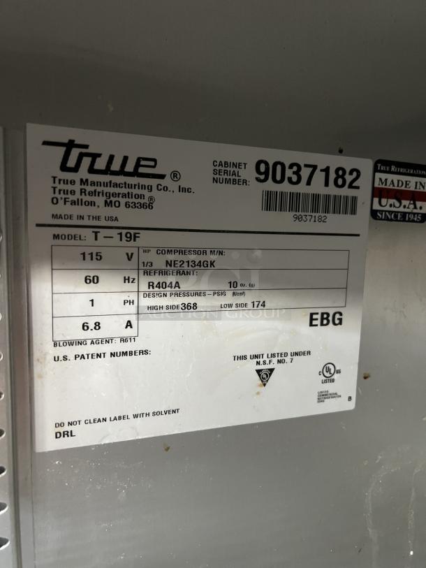 True T-19F commercial freezer with poly-coated racks, stainless steel, on casters. Model T-19F, SN: 9037182, 115V, 60Hz.