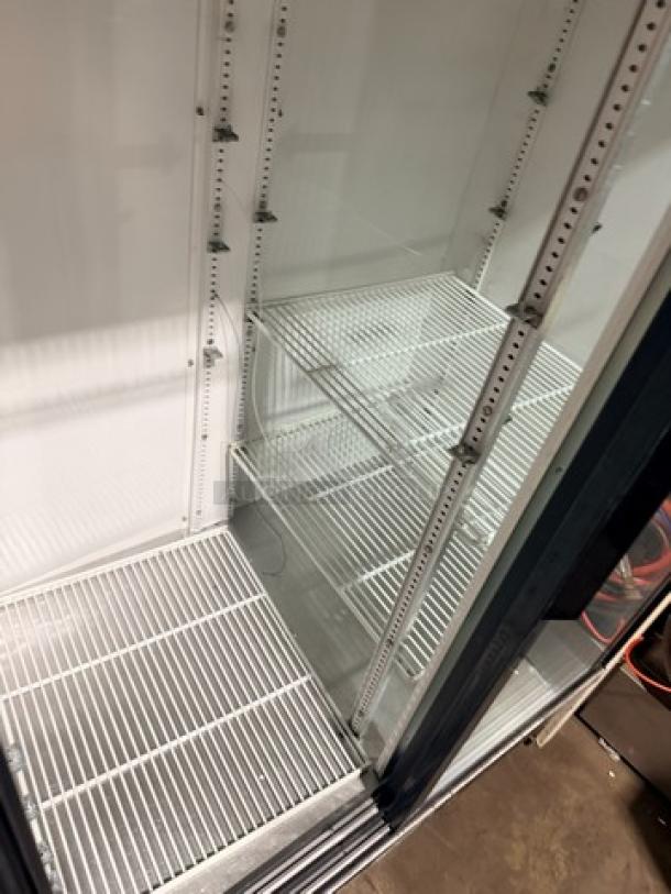 True GDM45 glass sliding door cooler, 115V, 1 phase, clean interior, adjustable shelves, excellent for display and storage.