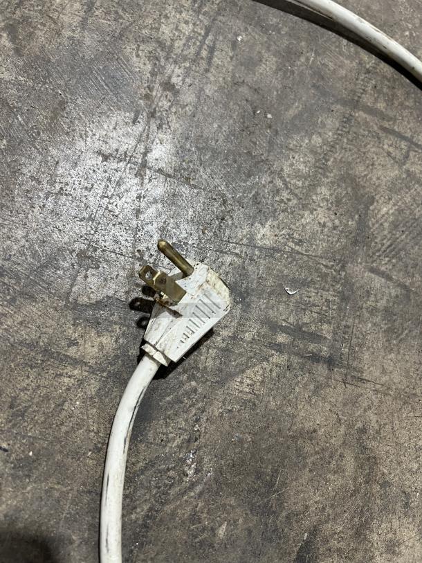 Alt text: Close-up of a worn electrical plug on a Starbucks CT200 Cooler. Plug shows signs of wear, indicative of used condition.