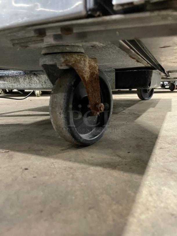 True TWT048 stainless steel 2-door undercounter worktop refrigerator, model TWT0-48, on casters, 115V, lightly rusted caster.