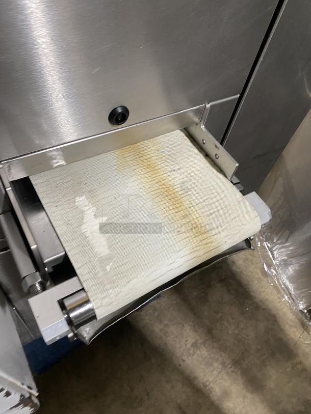 Benier stainless steel dough divider, industrial bakery machine, conveyor view, shows wear, robust construction.