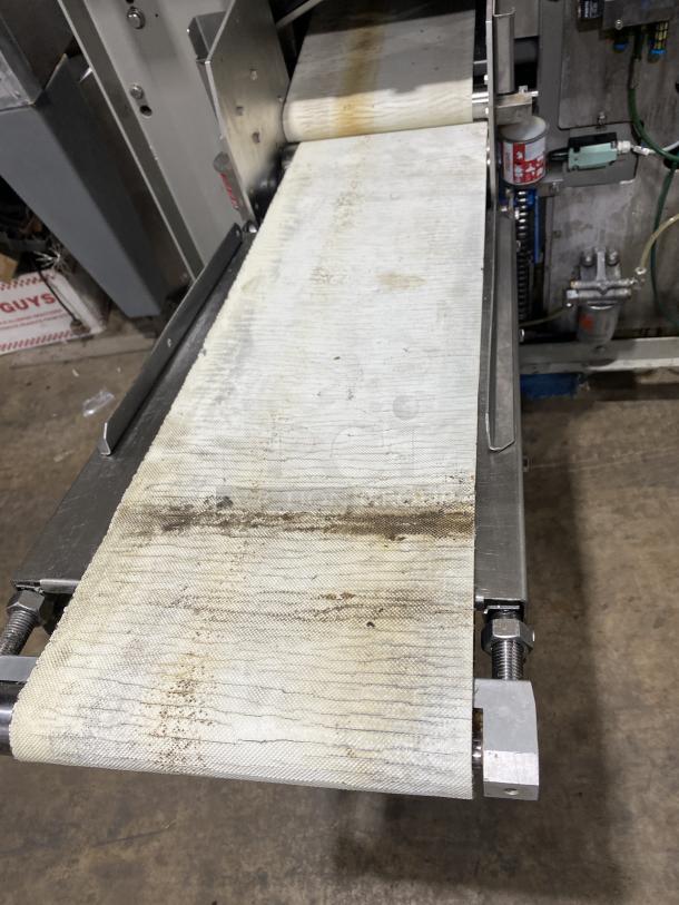 Benier stainless steel industrial dough divider machine, used condition, visible conveyor belt wear, commercial bakery equipment.