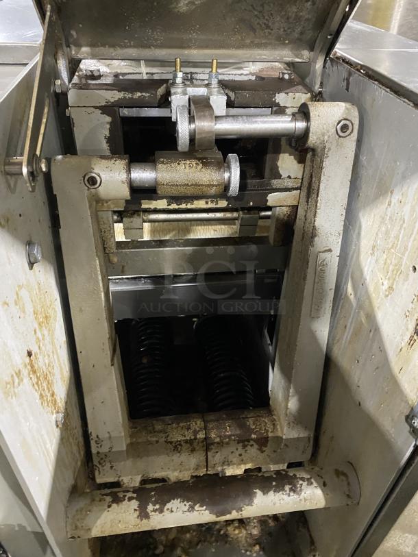 Benier commercial stainless steel dough divider bakery machine, showing internal parts and signs of wear.