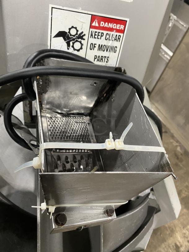 Benier stainless steel conical dough rounder machine on casters, showing wiring and safety warning label.