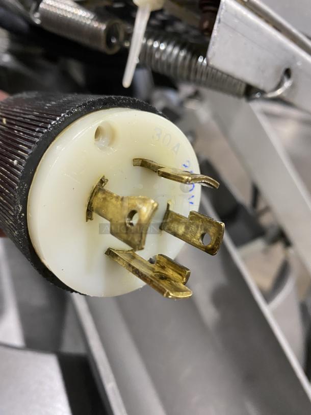 Commercial dough rounder machine plug, 30A, 250V, brass prongs visible. Part of Benier conical dough rounder.