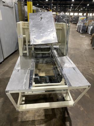 Commercial stainless steel dough sheeter machine, industrial-grade, featuring sturdy construction, visible wear, and motor components.