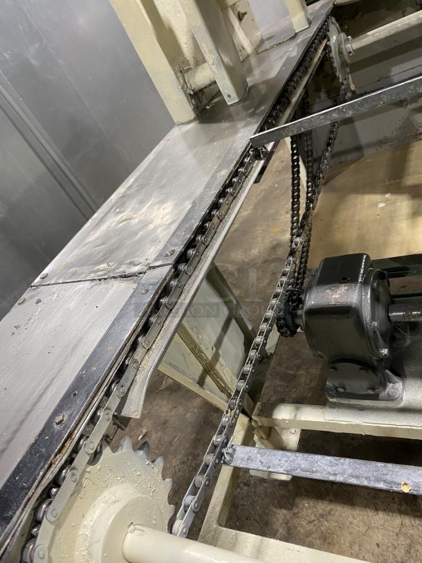 Commercial stainless steel dough sheeter machine with chain mechanism. Used condition, suitable for bakery operations.